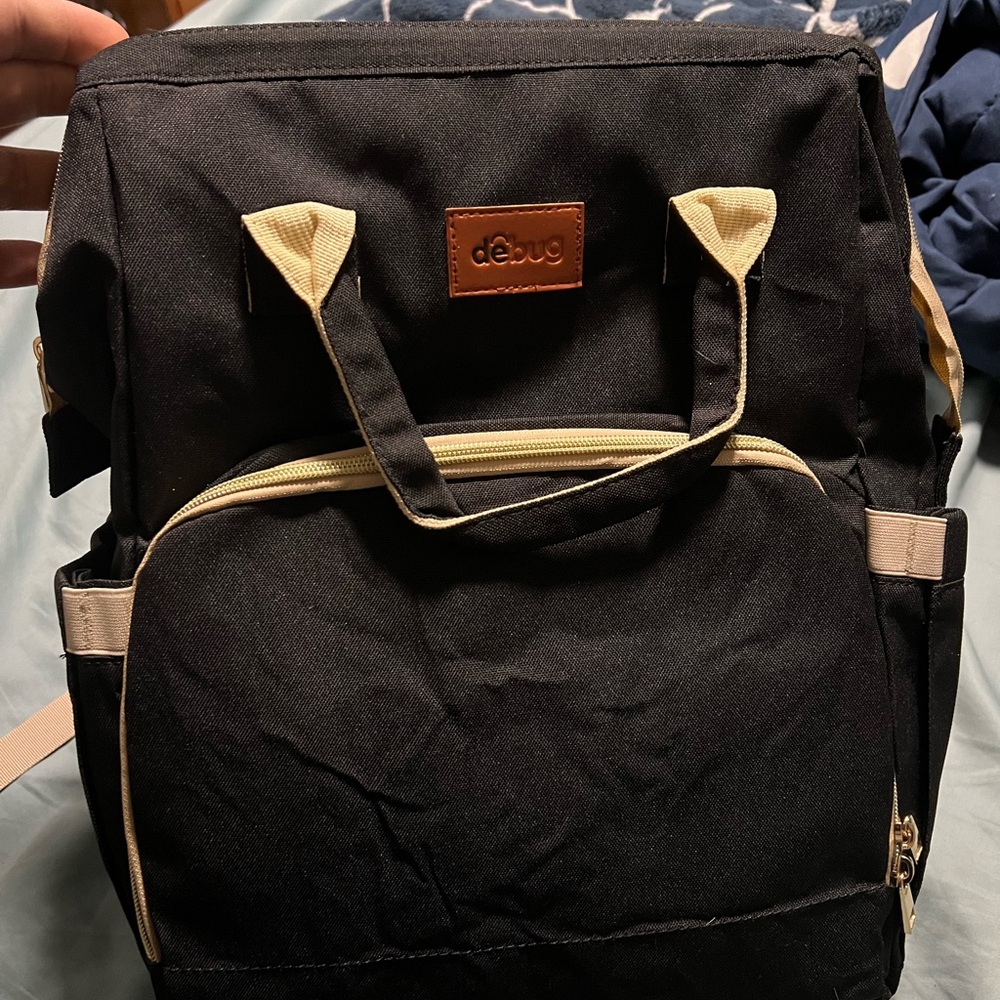 Debug diaper bag with changing pad